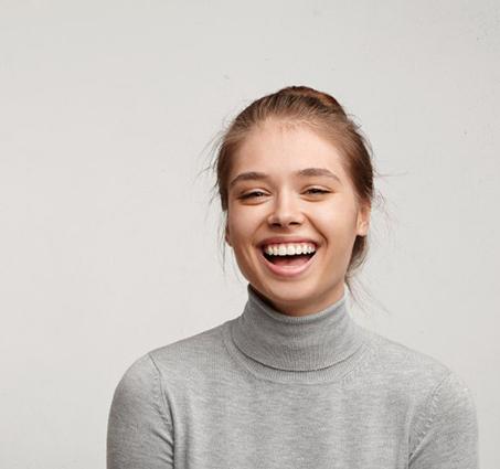 Young woman smiling on white background