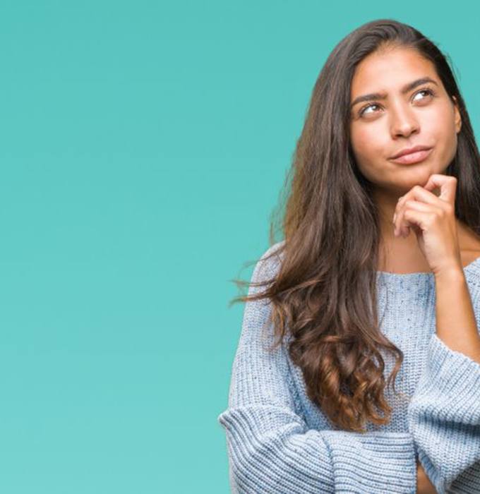 Young woman wondering why she needs a regular checkup and cleaning