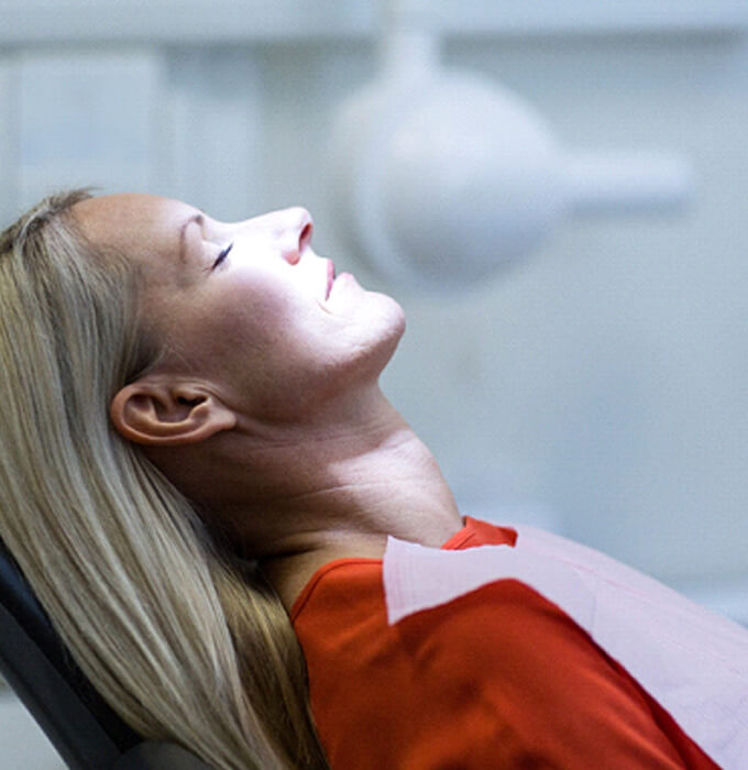 woman sitting in dental chair relaxing