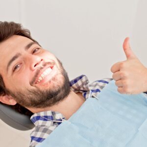 happy dental patient giving a thumbs up